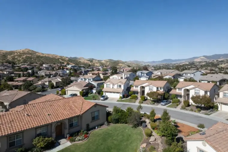 Aerial view of a Temecula subdivision with tile-roofed homes stretching toward rolling hills, the kind of post-1990 tract funded through a Community Facilities District